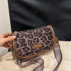 Sleek suede purse with wide shoulder strap