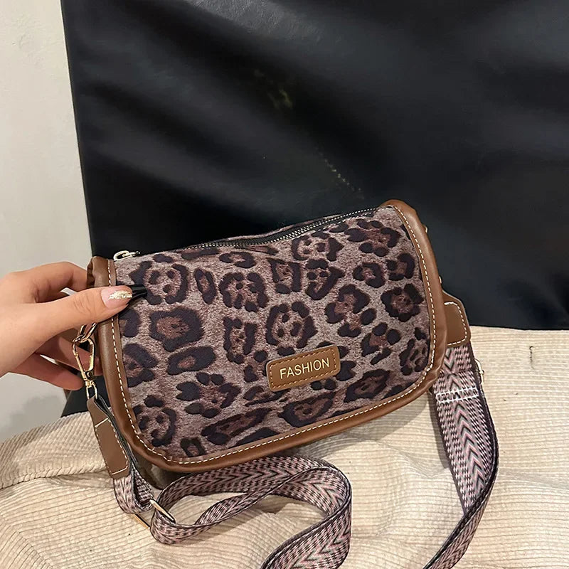 Sleek suede purse with wide shoulder strap