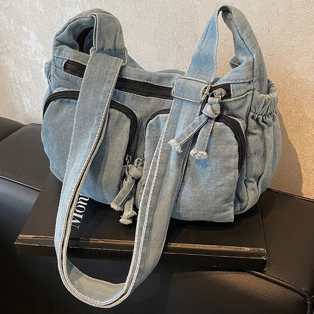 Denim shoulder bag with front pockets and buckle strap