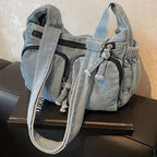 Denim shoulder bag with front pockets and buckle strap