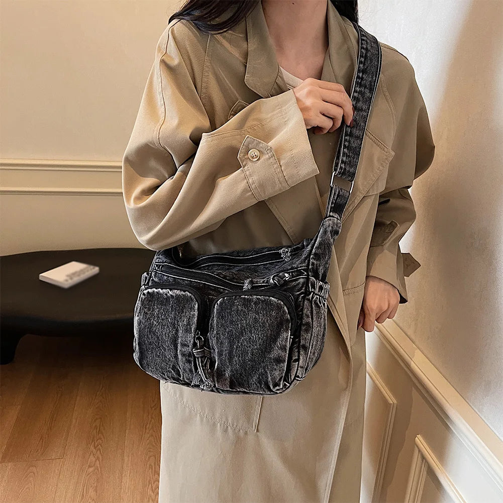 Denim shoulder bag with front pockets and buckle strap