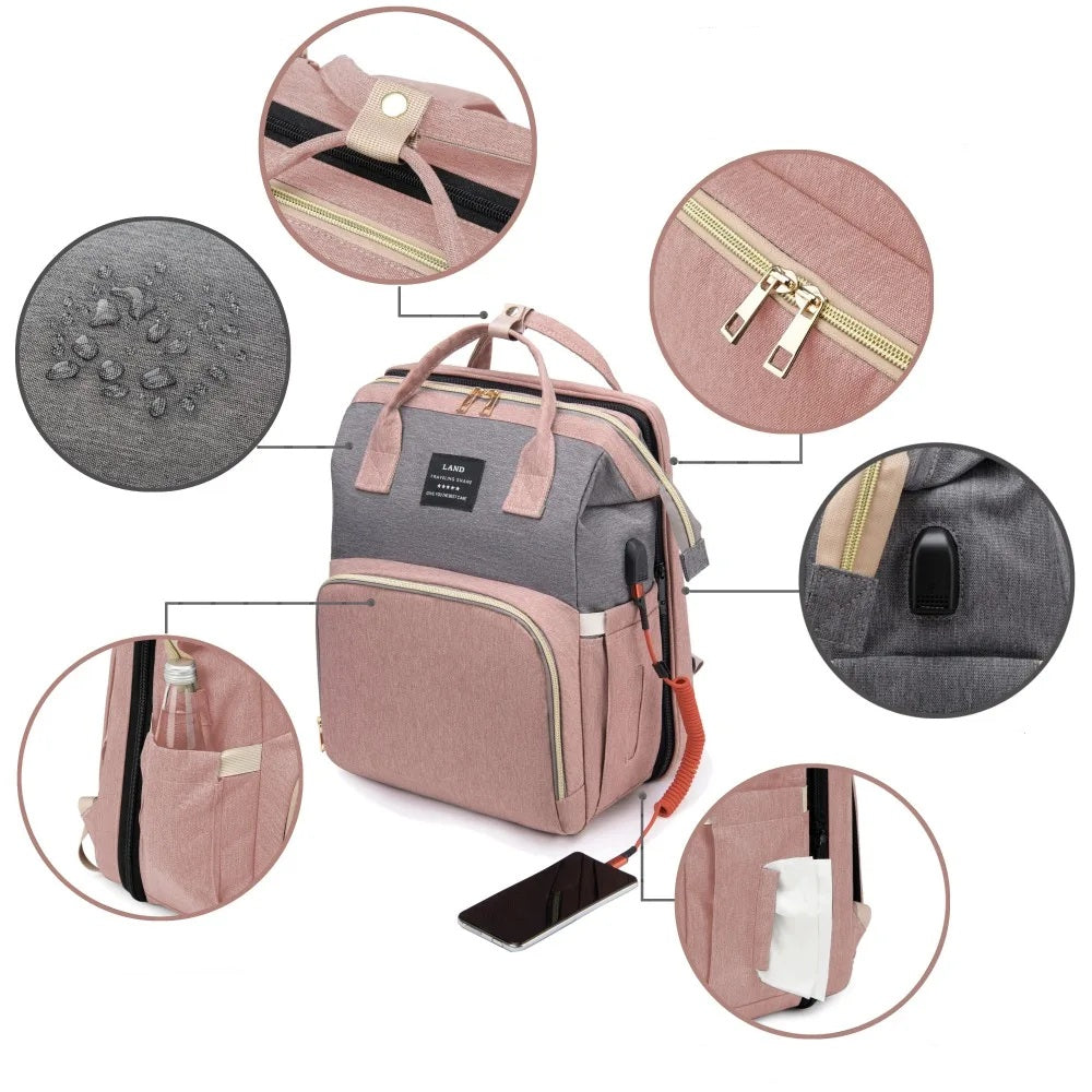 Pink diaper backpack with built-in bed