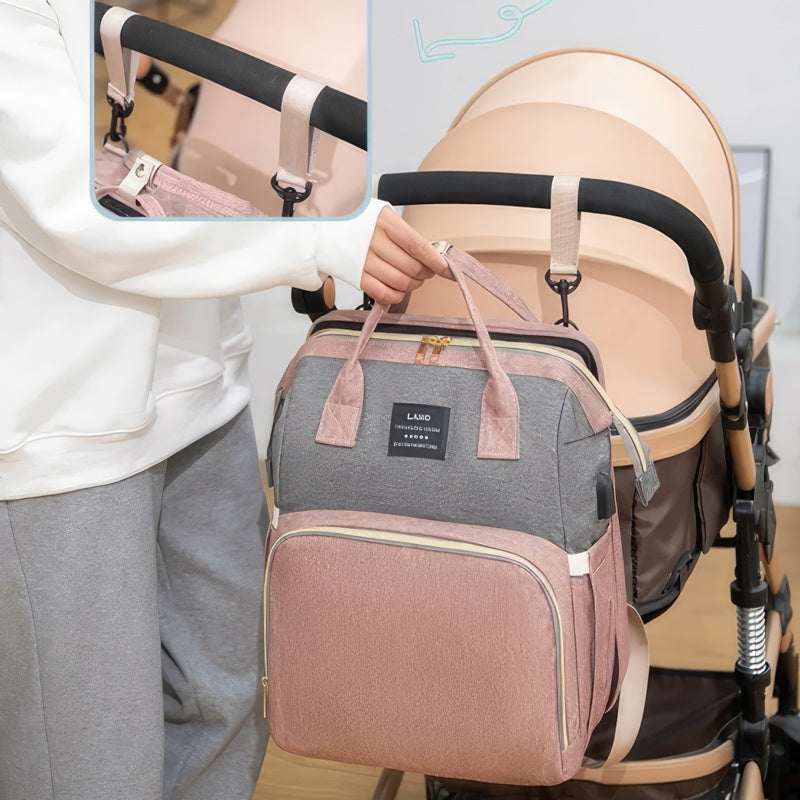 Pink diaper backpack with built-in bed