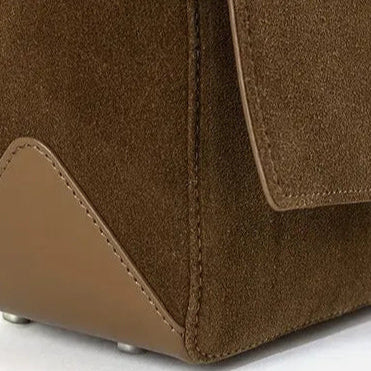 Textured suede handbag with flap closure