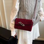 Structured suede handbag with minimalist shape