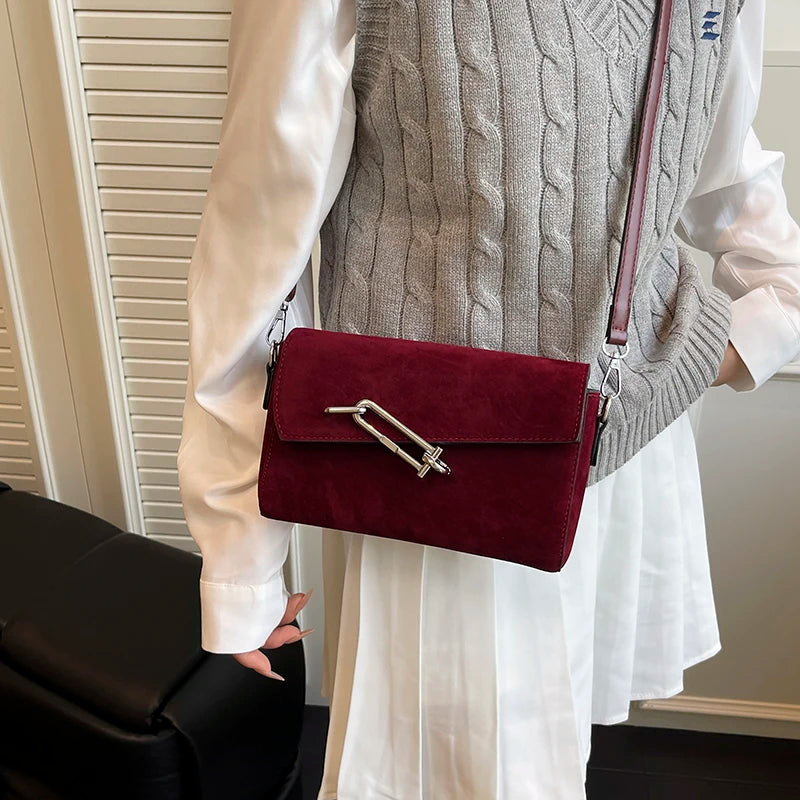 Structured suede handbag with minimalist shape