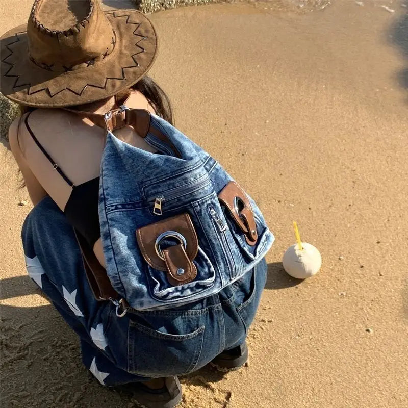 Trendy denim backpack with leather strap detail