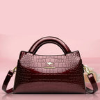 Soft leather handbag with curved top edge