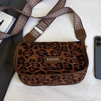 Sleek suede purse with wide shoulder strap