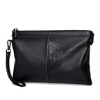 Minimalist leather clutch with detachable strap
