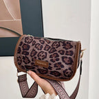 Sleek suede purse with wide shoulder strap