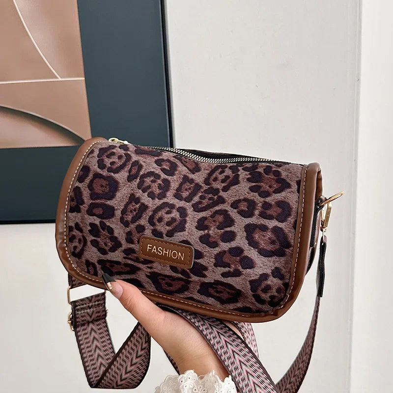 Sleek suede purse with wide shoulder strap