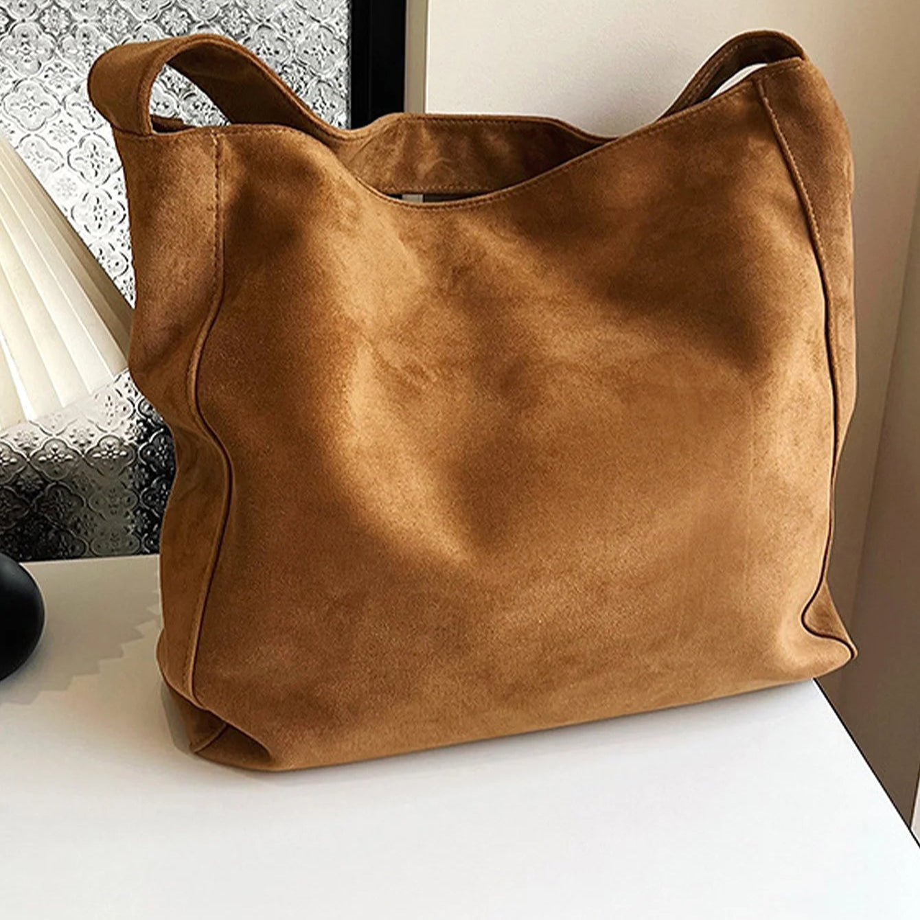Suede slouch bag with relaxed boho silhouette