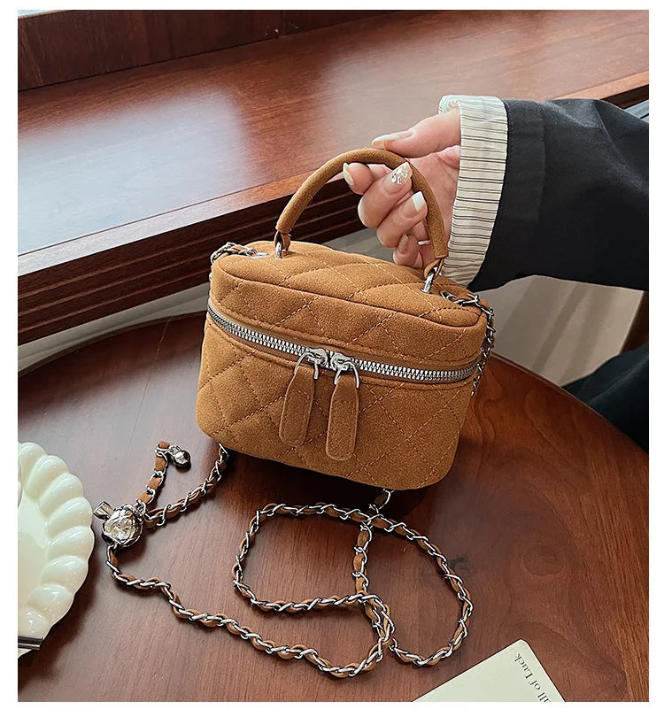 Classic suede handbag with structured handle
