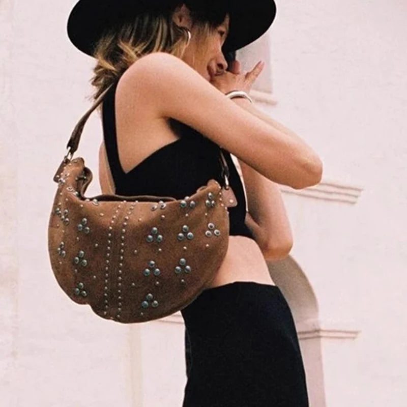 Soft suede handbag with elegant curved silhouette