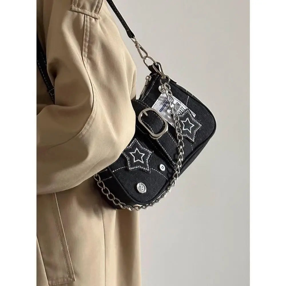 Edgy black denim handbag with buckle strap