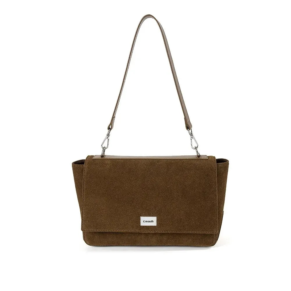 Textured suede handbag with flap closure