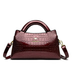 Soft leather handbag with curved top edge
