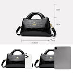 Soft leather handbag with curved top edge