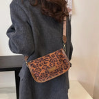 Sleek suede purse with wide shoulder strap