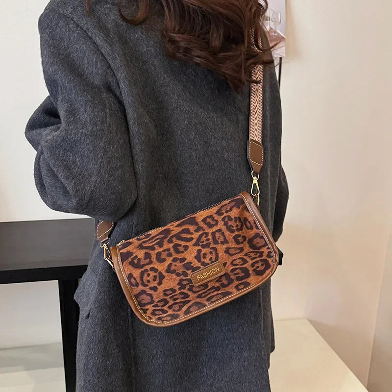 Sleek suede purse with wide shoulder strap