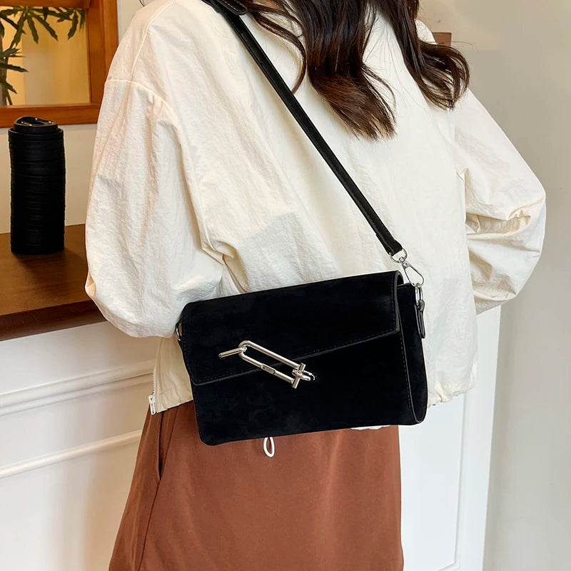 Structured suede handbag with minimalist shape