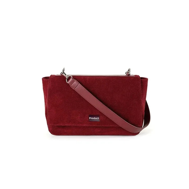 Textured suede handbag with flap closure