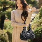 Leather shoulder bag with side pockets