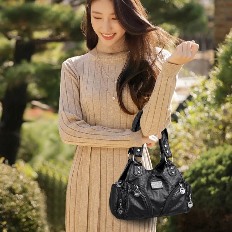 Leather shoulder bag with side pockets