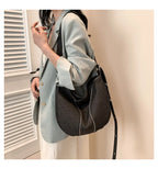 Amblot Black Soft washed denim shoulder bag with casual fold design