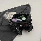 Amblot Denim shoulder bag with front pockets and buckle strap