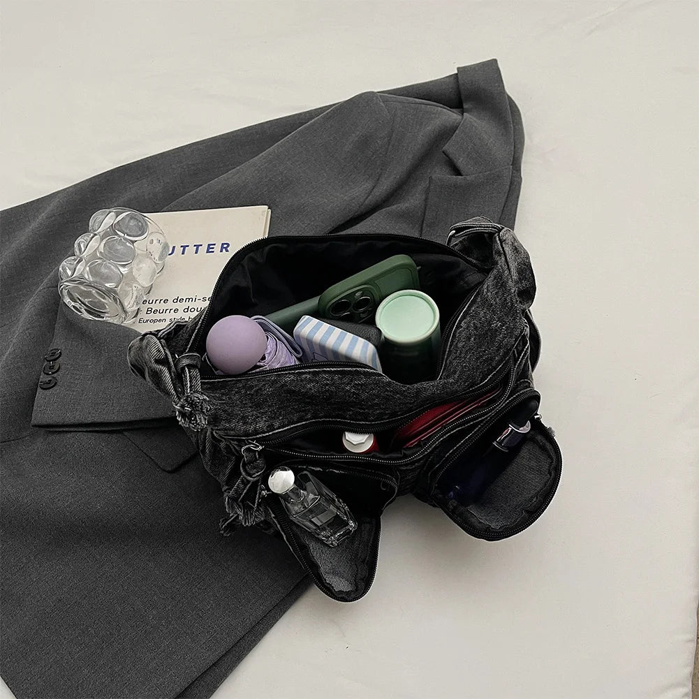 Amblot Denim shoulder bag with front pockets and buckle strap