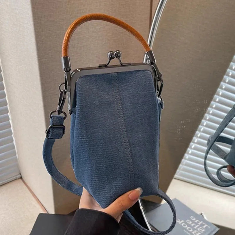 Amblot Distressed denim clutch bag with vintage vibes