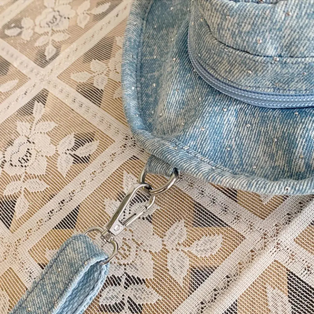 Amblot Round denim crossbody bag with fringe and zip closure