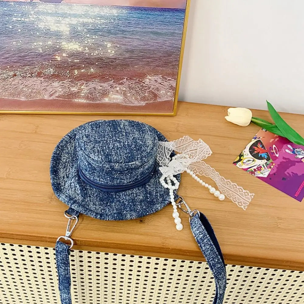 Amblot Round denim crossbody bag with fringe and zip closure