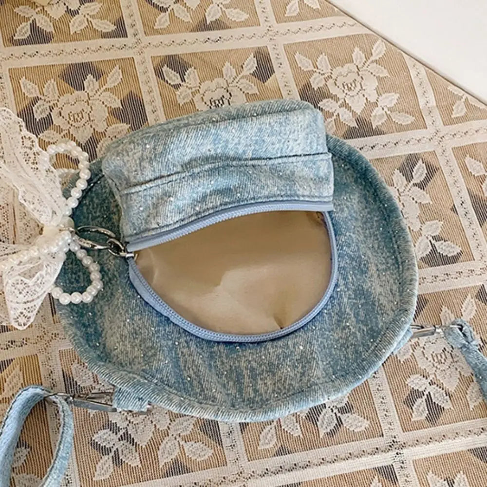 Amblot Round denim crossbody bag with fringe and zip closure