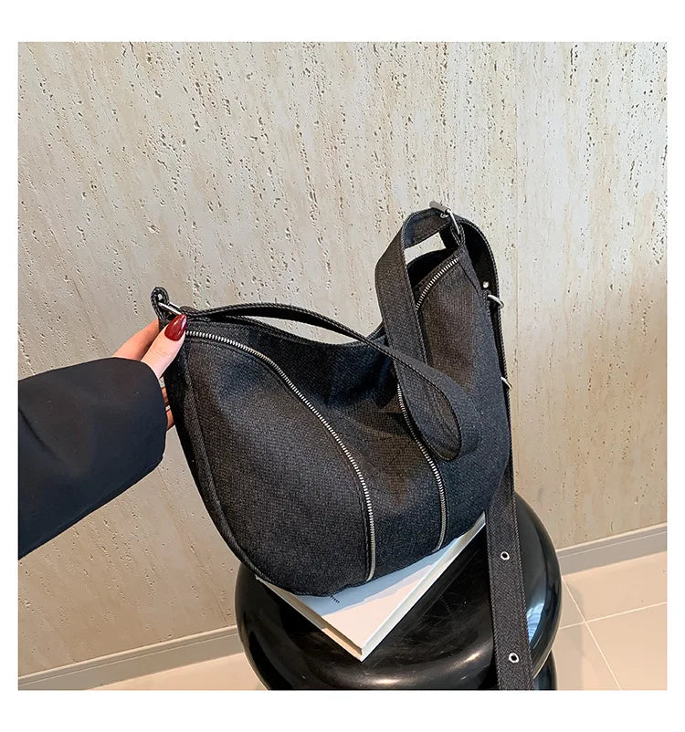 Amblot Soft washed denim shoulder bag with casual fold design