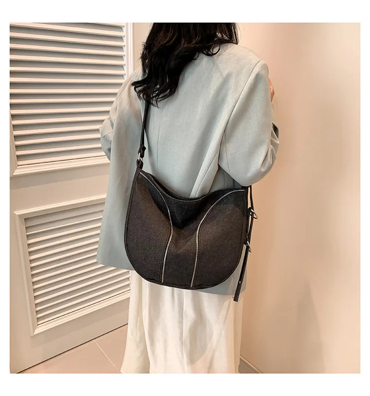 Amblot Soft washed denim shoulder bag with casual fold design