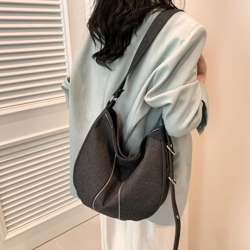 Amblot Soft washed denim shoulder bag with casual fold design