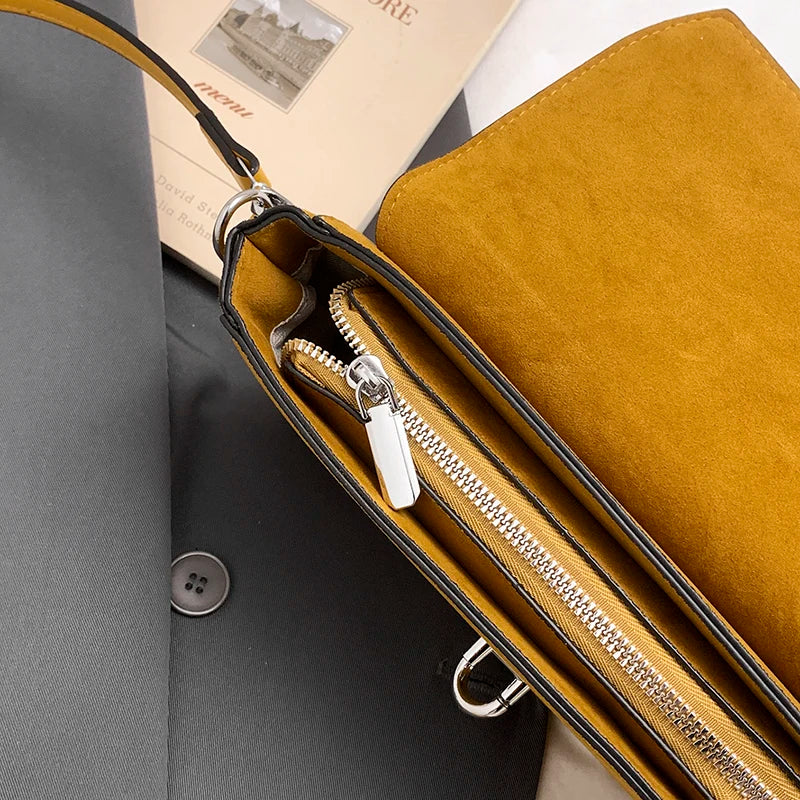 Amblot Structured suede handbag with minimalist shape